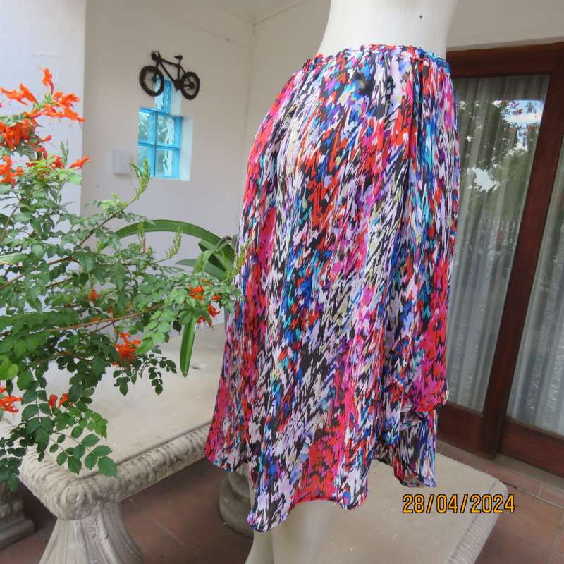 Cheerful sheer polyester gathered skirt/elastic waist. Array of colours. Size 36.Asymmetrical waist