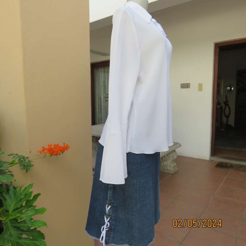 Pretty white polyester slip over top with long sleeves/flare cuffs. Front braided opening.Size 38/40