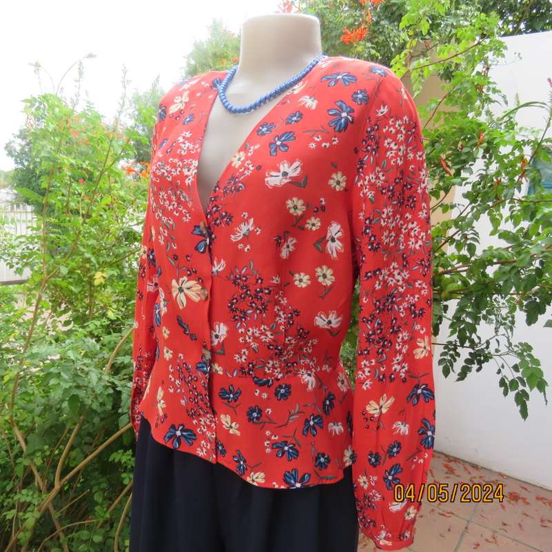 Make a statement. Apple red cream/blue floral long sleeve viscose top.Peplum/V neck. By H&M size 38
