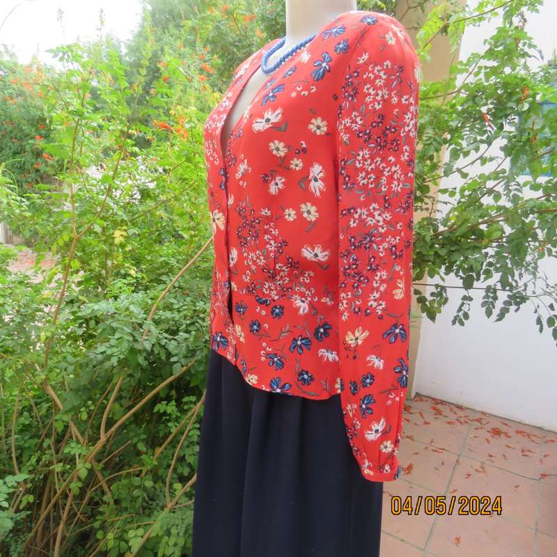 Make a statement. Apple red cream/blue floral long sleeve viscose top.Peplum/V neck. By H&M size 38