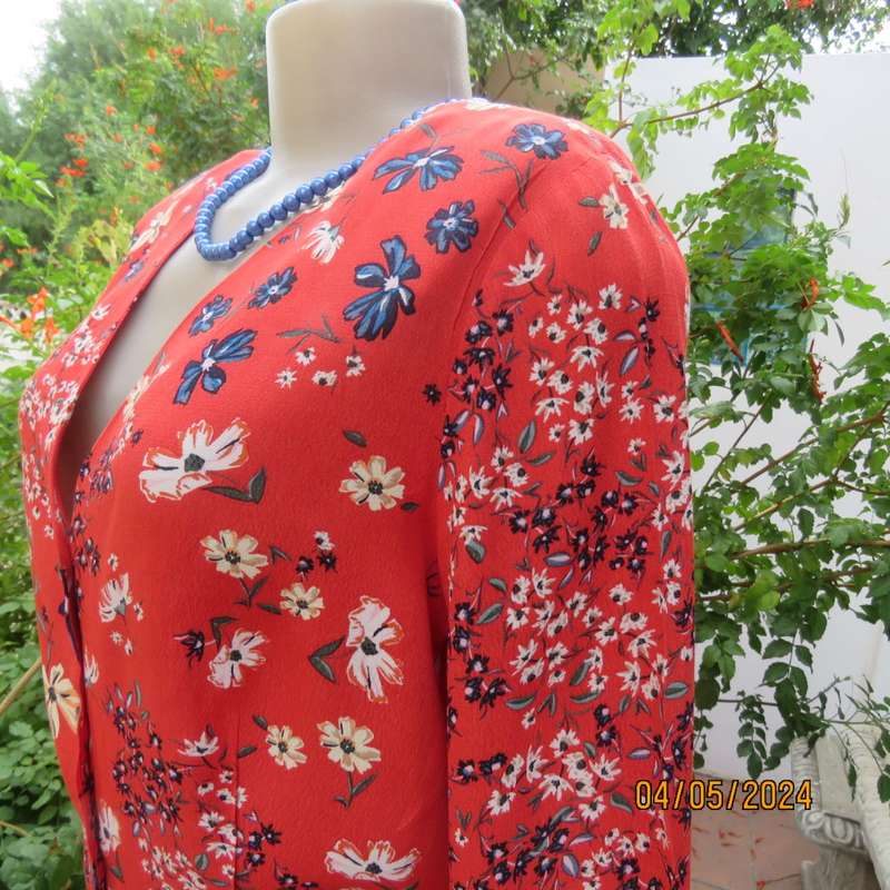 Make a statement. Apple red cream/blue floral long sleeve viscose top.Peplum/V neck. By H&M size 38