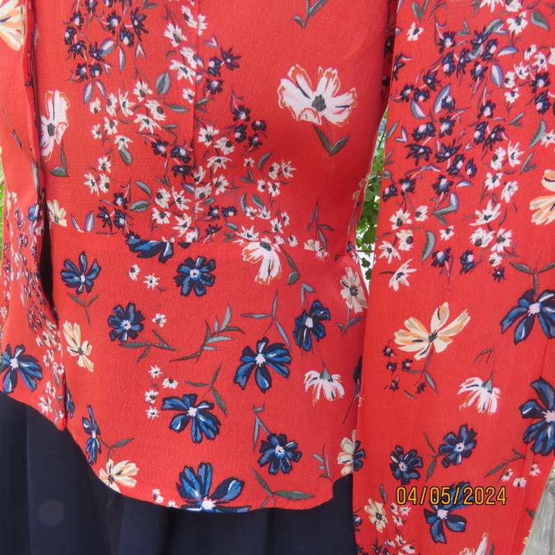 Make a statement. Apple red cream/blue floral long sleeve viscose top.Peplum/V neck. By H&M size 38