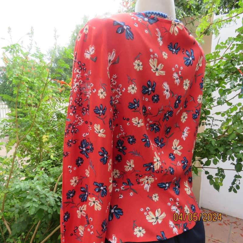 Make a statement. Apple red cream/blue floral long sleeve viscose top.Peplum/V neck. By H&M size 38