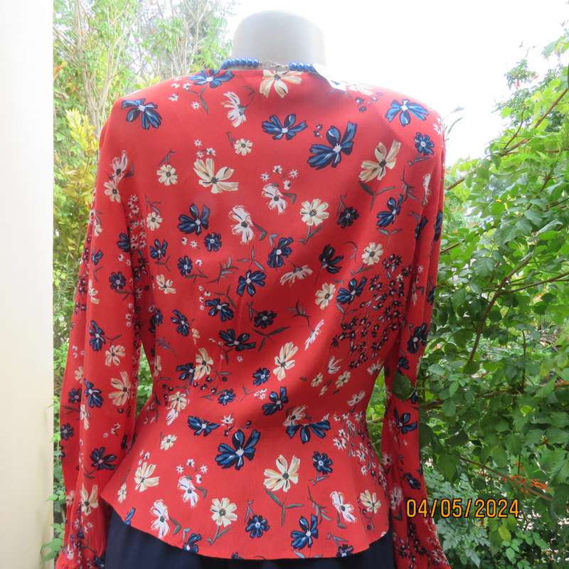 Make a statement. Apple red cream/blue floral long sleeve viscose top.Peplum/V neck. By H&M size 38
