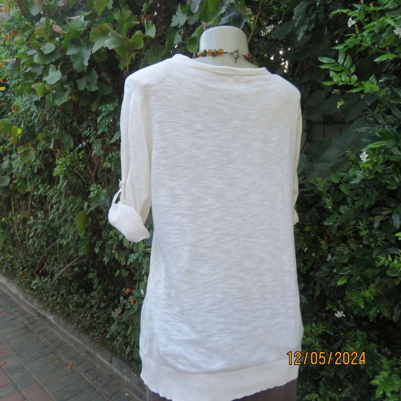 Soft cream cotton/rayon knit button down top. Scooped neckline. Elbow roll up sleeves.By TRU size 38