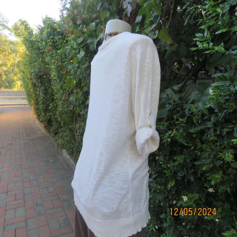 Soft cream cotton/rayon knit button down top. Scooped neckline. Elbow roll up sleeves.By TRU size 38