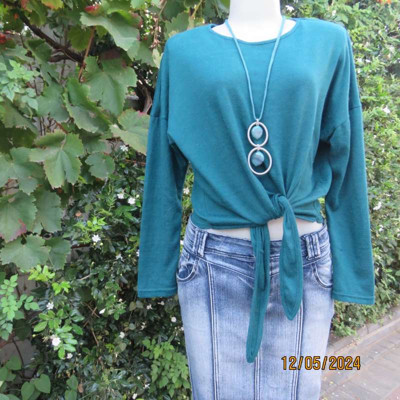 Pretty soft warm acrylic knit long sleeve  top with stretch. Straps to tie on front. Size 38. As new