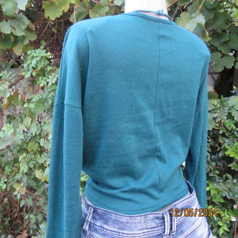 Pretty soft warm acrylic knit long sleeve  top with stretch. Straps to tie on front. Size 38. As new