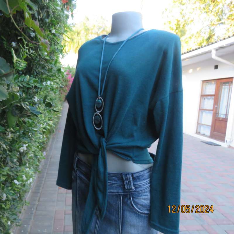 Pretty soft warm acrylic knit long sleeve  top with stretch. Straps to tie on front. Size 38. As new