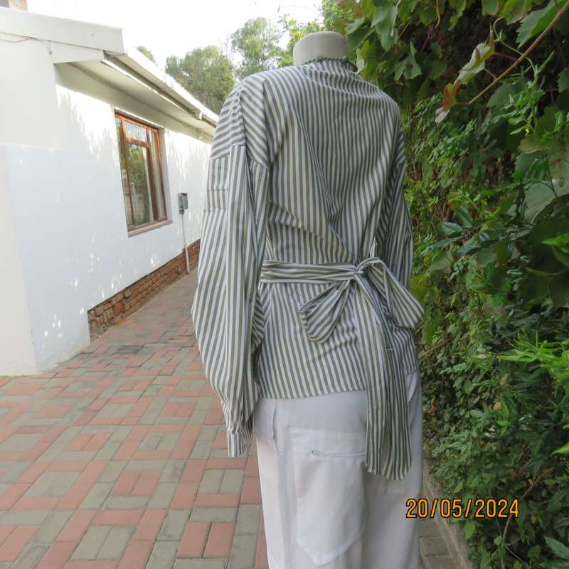 Look at me fold over V neck polycotton peplum style top. White/olive stripes. Unique sleeves.Size 34