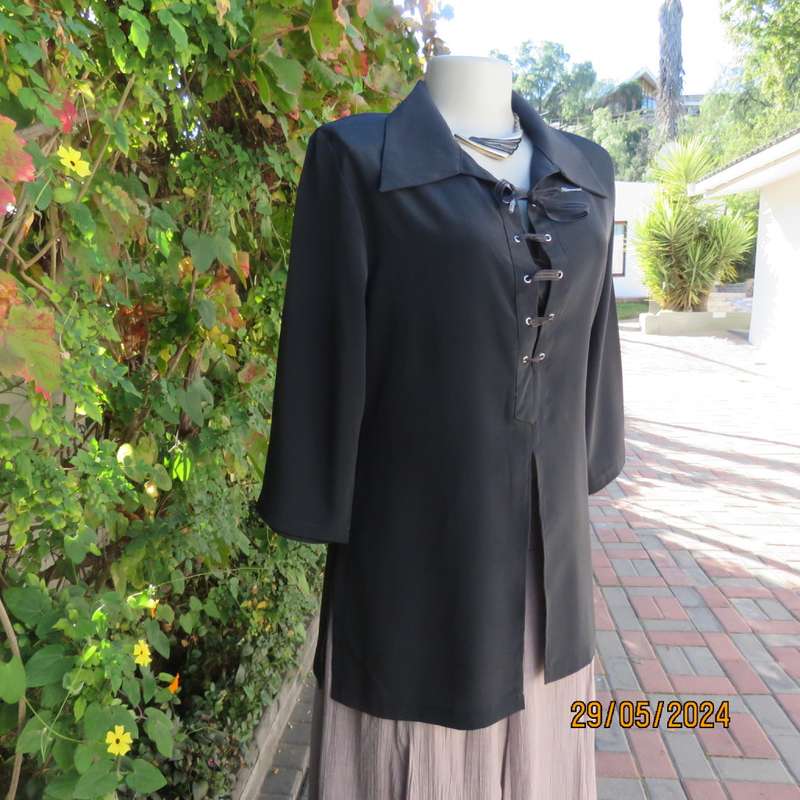 Beautiful black shiny polyester blend slip over top with elbow length sleeves. Braided front.Size 36