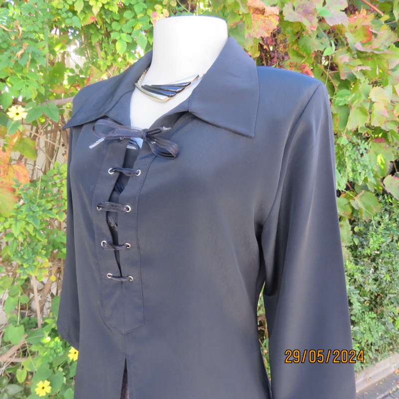 Beautiful black shiny polyester blend slip over top with elbow length sleeves. Braided front.Size 36