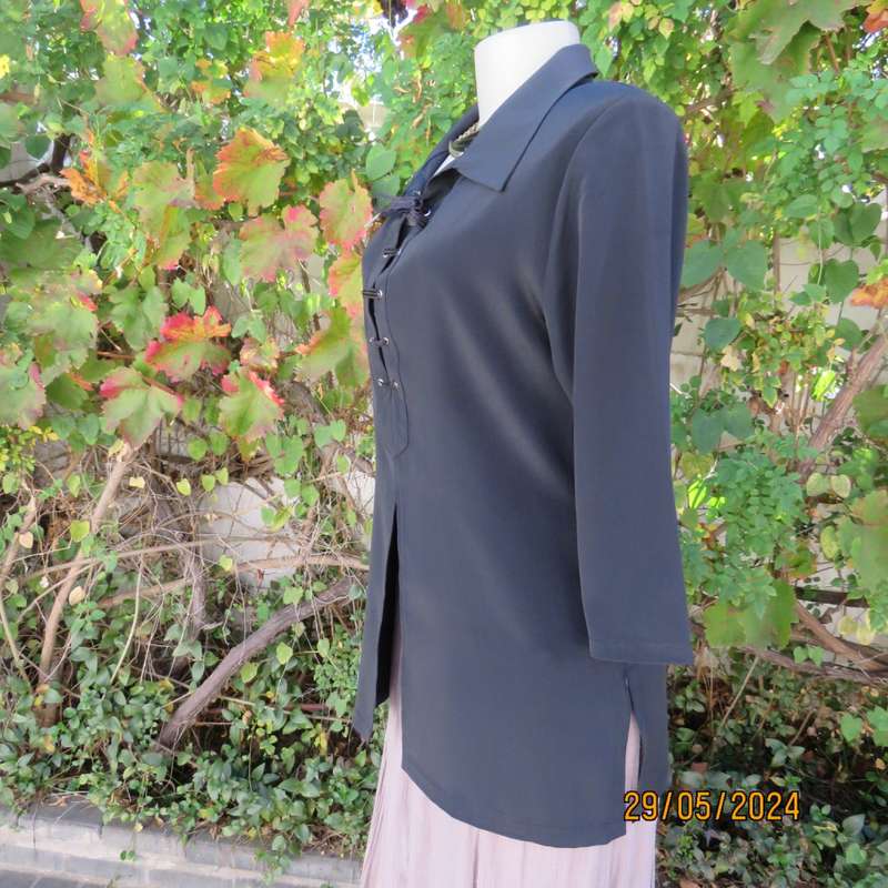 Beautiful black shiny polyester blend slip over top with elbow length sleeves. Braided front.Size 36