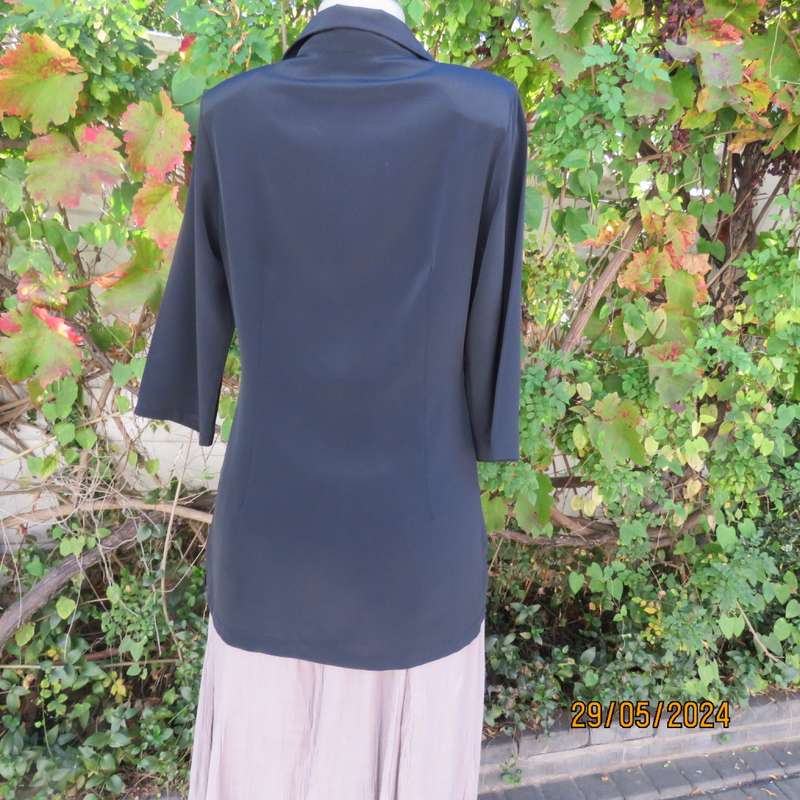 Beautiful black shiny polyester blend slip over top with elbow length sleeves. Braided front.Size 36