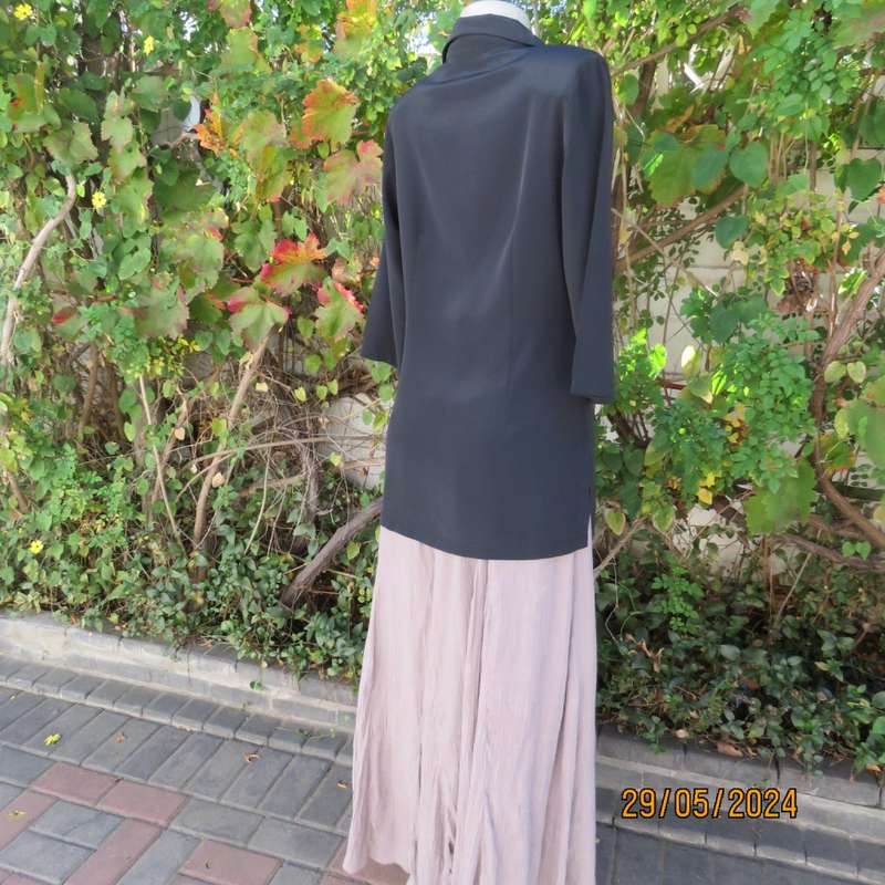 Beautiful black shiny polyester blend slip over top with elbow length sleeves. Braided front.Size 36