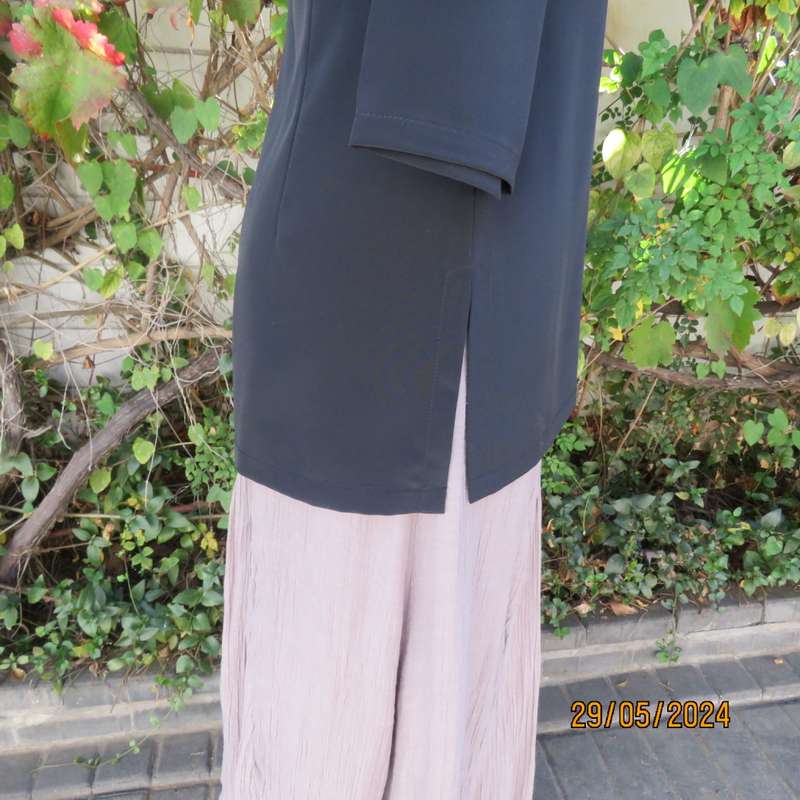 Beautiful black shiny polyester blend slip over top with elbow length sleeves. Braided front.Size 36