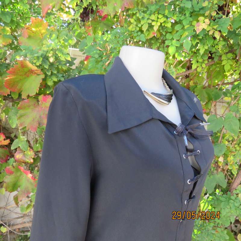Beautiful black shiny polyester blend slip over top with elbow length sleeves. Braided front.Size 36