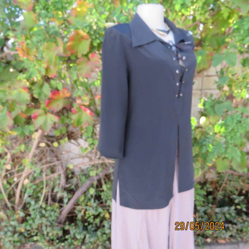 Beautiful black shiny polyester blend slip over top with elbow length sleeves. Braided front.Size 36