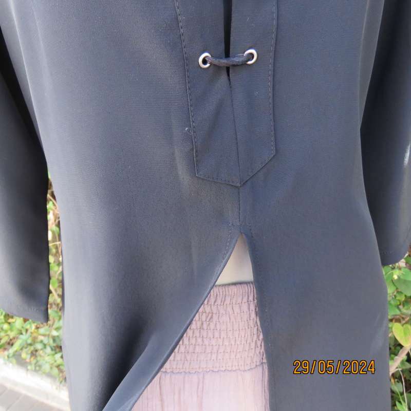 Beautiful black shiny polyester blend slip over top with elbow length sleeves. Braided front.Size 36