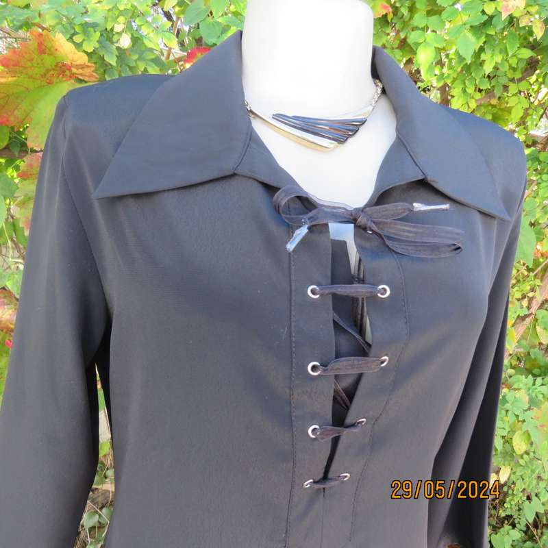 Beautiful black shiny polyester blend slip over top with elbow length sleeves. Braided front.Size 36