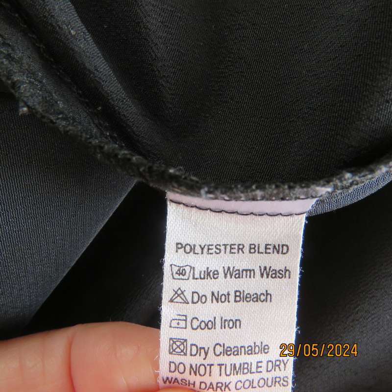 Beautiful black shiny polyester blend slip over top with elbow length sleeves. Braided front.Size 36