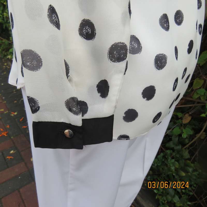 Pretty white sheer poly/black polkadot long sleeve top by RT size 36. Black collar, cuffs, front.