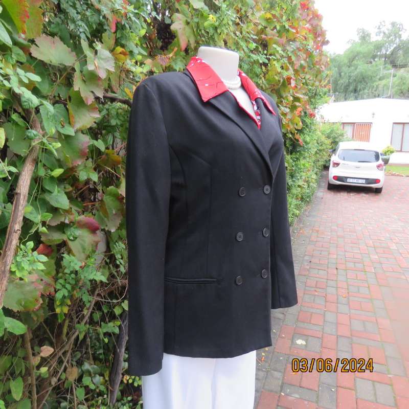 Elegant double breasted black long sleeve tailored poly/rayon jacket. Partly lined.By DIJON size 36.