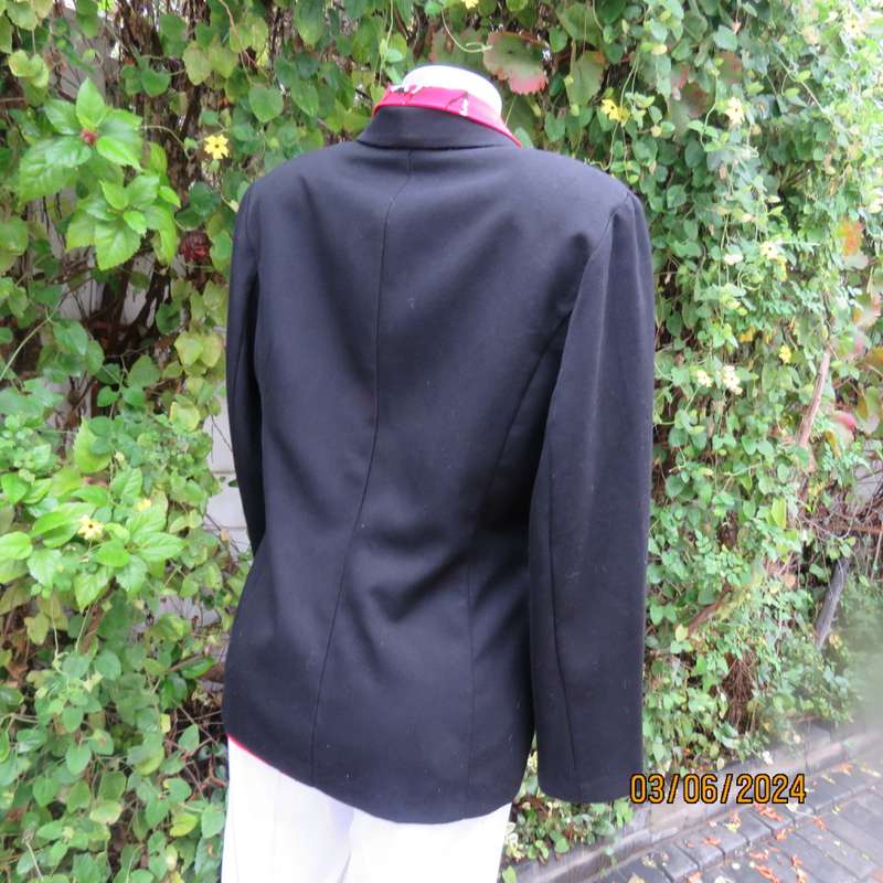 Elegant double breasted black long sleeve tailored poly/rayon jacket. Partly lined.By DIJON size 36.