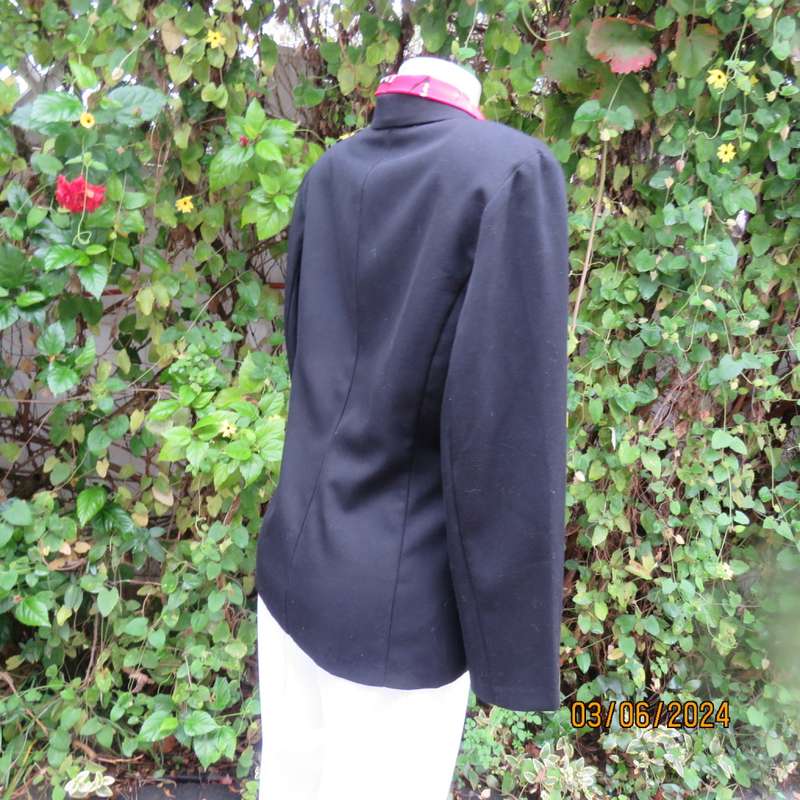 Elegant double breasted black long sleeve tailored poly/rayon jacket. Partly lined.By DIJON size 36.