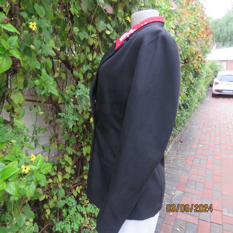 Elegant double breasted black long sleeve tailored poly/rayon jacket. Partly lined.By DIJON size 36.