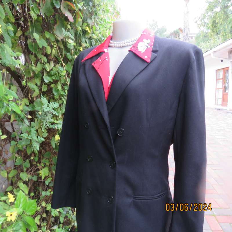 Elegant double breasted black long sleeve tailored poly/rayon jacket. Partly lined.By DIJON size 36.