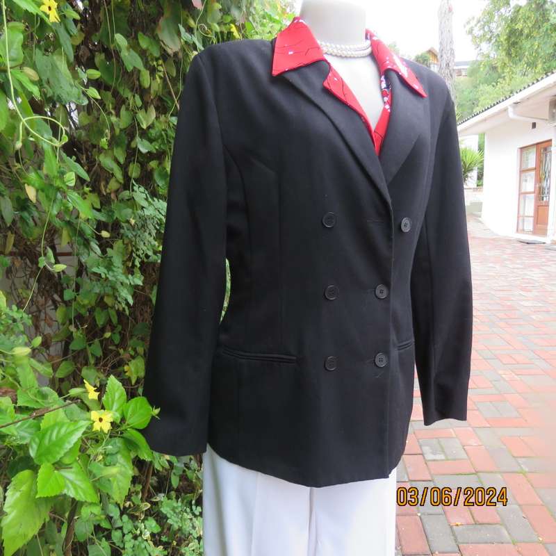 Elegant double breasted black long sleeve tailored poly/rayon jacket. Partly lined.By DIJON size 36.