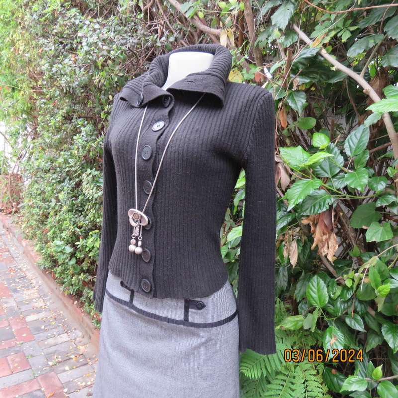 Very black rib stitch button down cardigan in acrylic yarn. Wear poloneck or open collar. Size 32/34