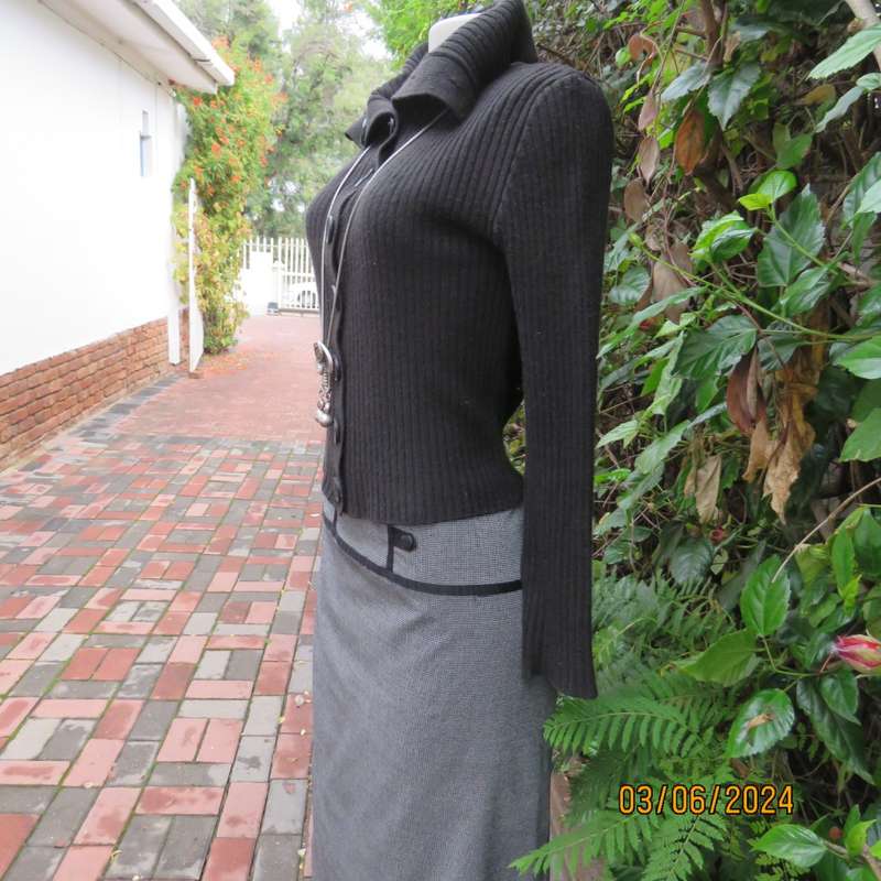 Very black rib stitch button down cardigan in acrylic yarn. Wear poloneck or open collar. Size 32/34