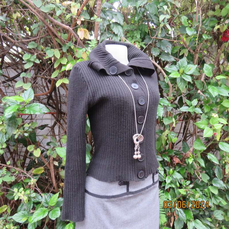 Very black rib stitch button down cardigan in acrylic yarn. Wear poloneck or open collar. Size 32/34