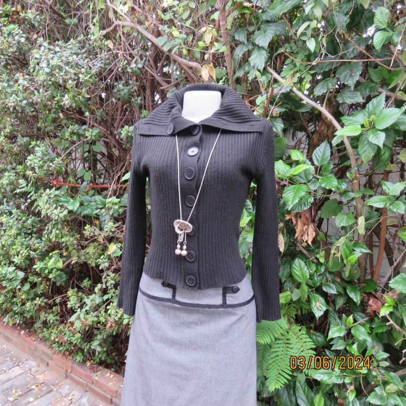 Very black rib stitch button down cardigan in acrylic yarn. Wear poloneck or open collar. Size 32/34