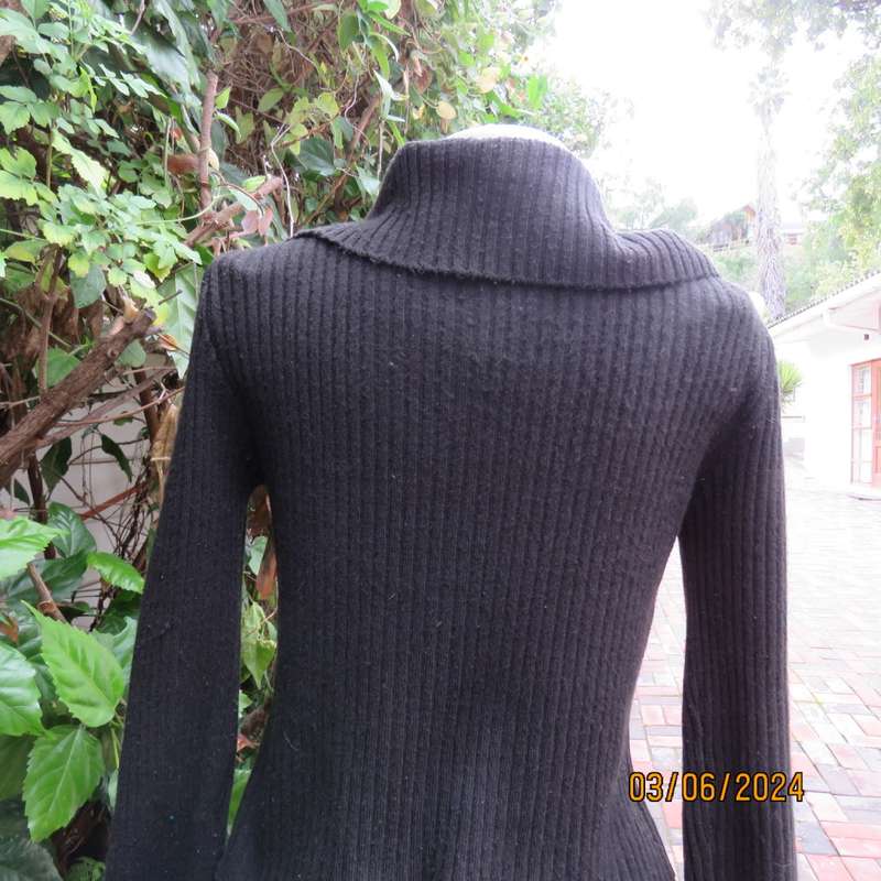 Very black rib stitch button down cardigan in acrylic yarn. Wear poloneck or open collar. Size 32/34