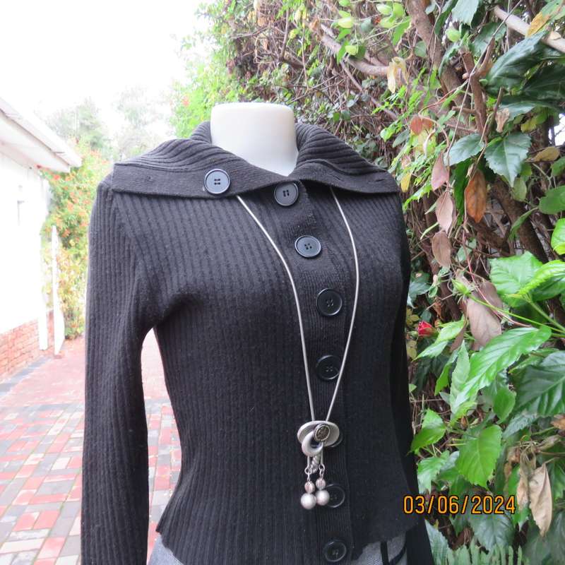 Very black rib stitch button down cardigan in acrylic yarn. Wear poloneck or open collar. Size 32/34