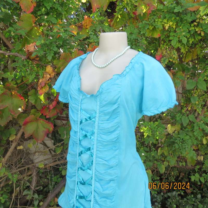 Feminine aquamarine blue peasant style top. Zip at side. Front gathered/decorated panels.Size 42.