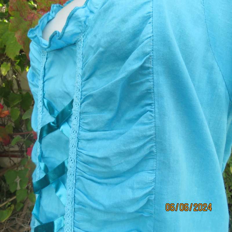 Feminine aquamarine blue peasant style top. Zip at side. Front gathered/decorated panels.Size 42.