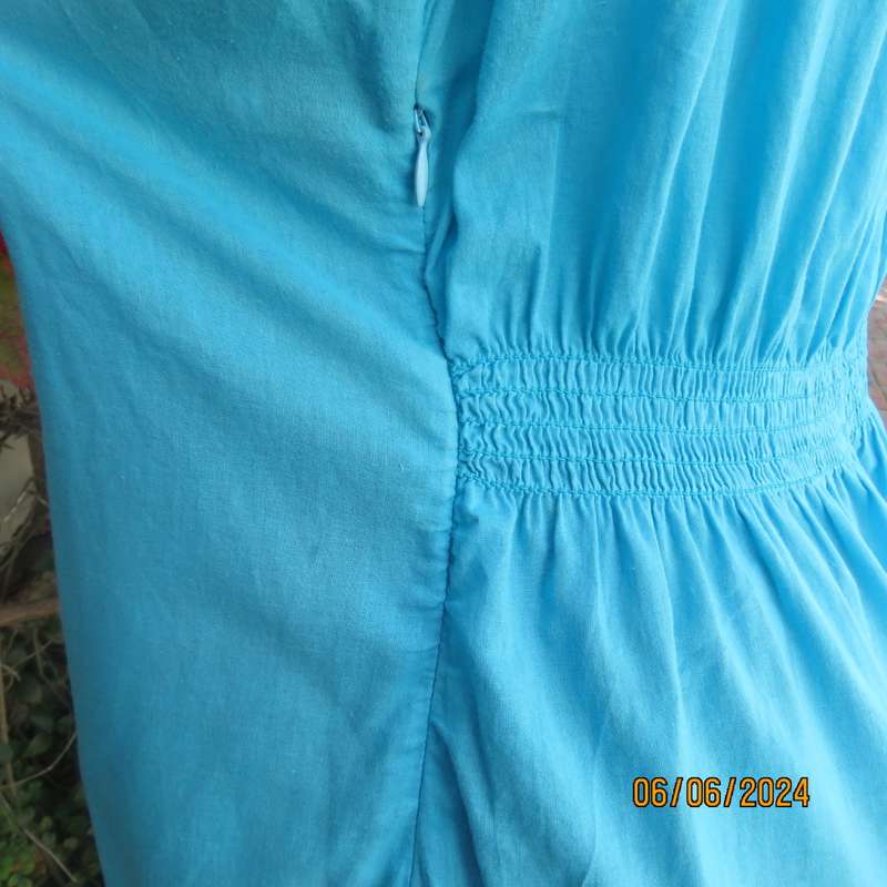 Feminine aquamarine blue peasant style top. Zip at side. Front gathered/decorated panels.Size 42.