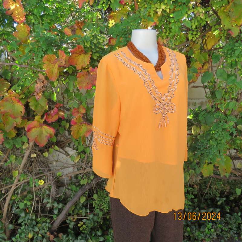 Eye catching tangerine crinkled polyester slip over top with high/low seamline.Size 38. New cond.