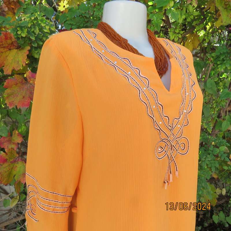 Eye catching tangerine crinkled polyester slip over top with high/low seamline.Size 38. New cond.