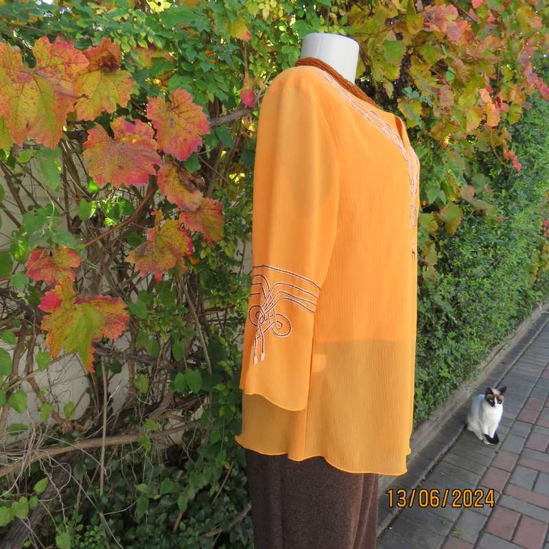 Eye catching tangerine crinkled polyester slip over top with high/low seamline.Size 38. New cond.