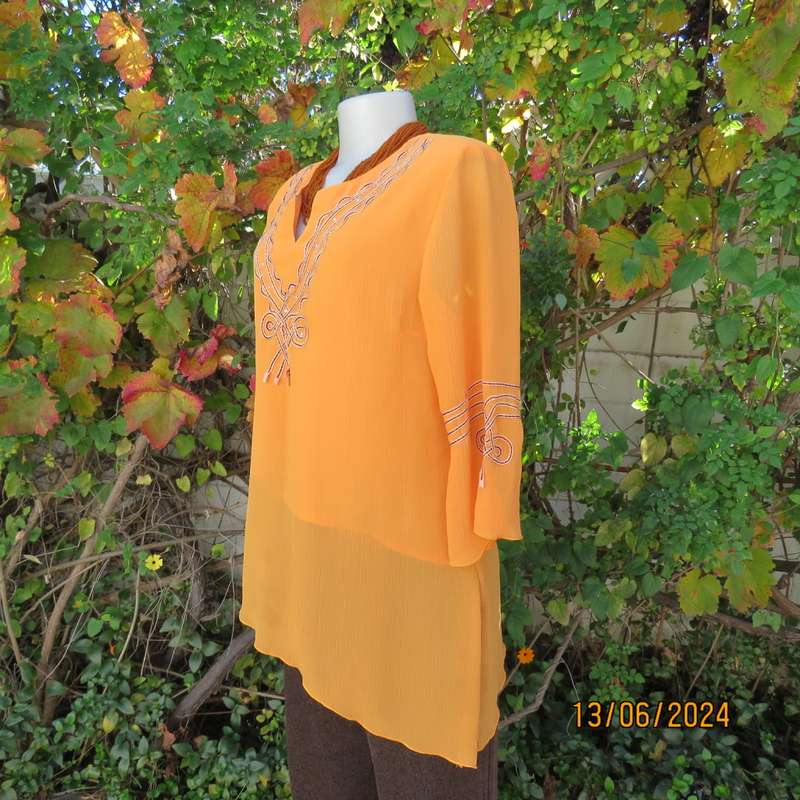 Eye catching tangerine crinkled polyester slip over top with high/low seamline.Size 38. New cond.