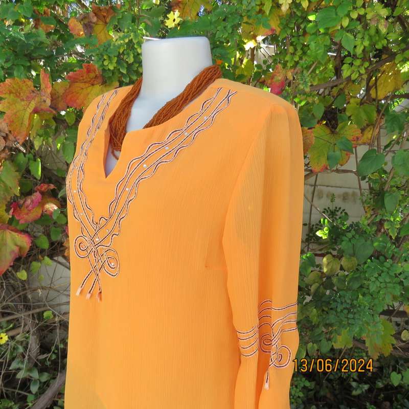 Eye catching tangerine crinkled polyester slip over top with high/low seamline.Size 38. New cond.