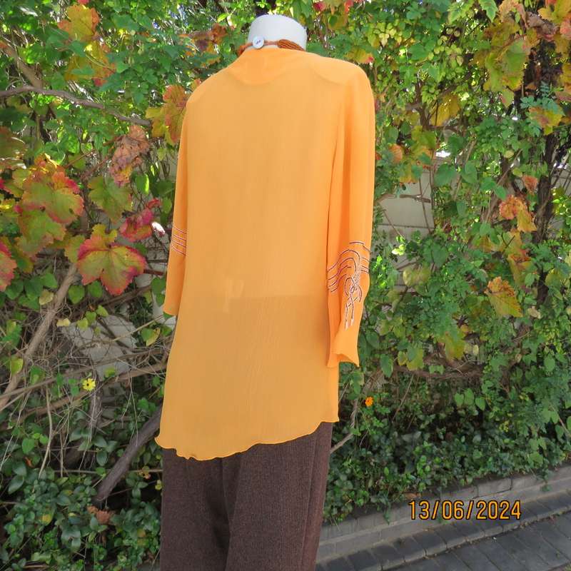 Eye catching tangerine crinkled polyester slip over top with high/low seamline.Size 38. New cond.