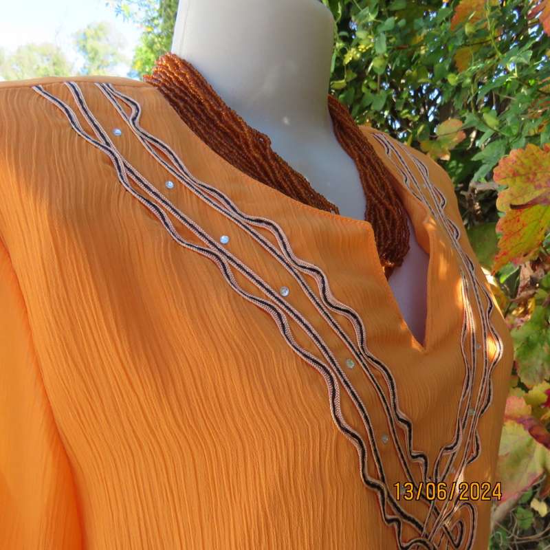 Eye catching tangerine crinkled polyester slip over top with high/low seamline.Size 38. New cond.