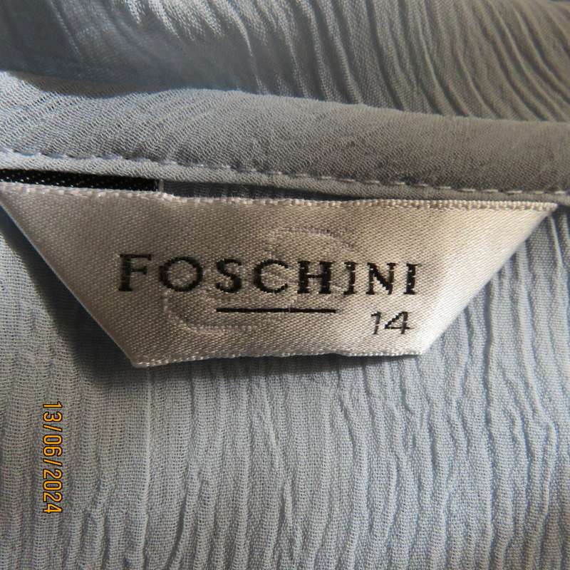 Dainty powder blue long sleeve cover-up in crinkled polyester. 3 tiny button closure.Size 38. As new