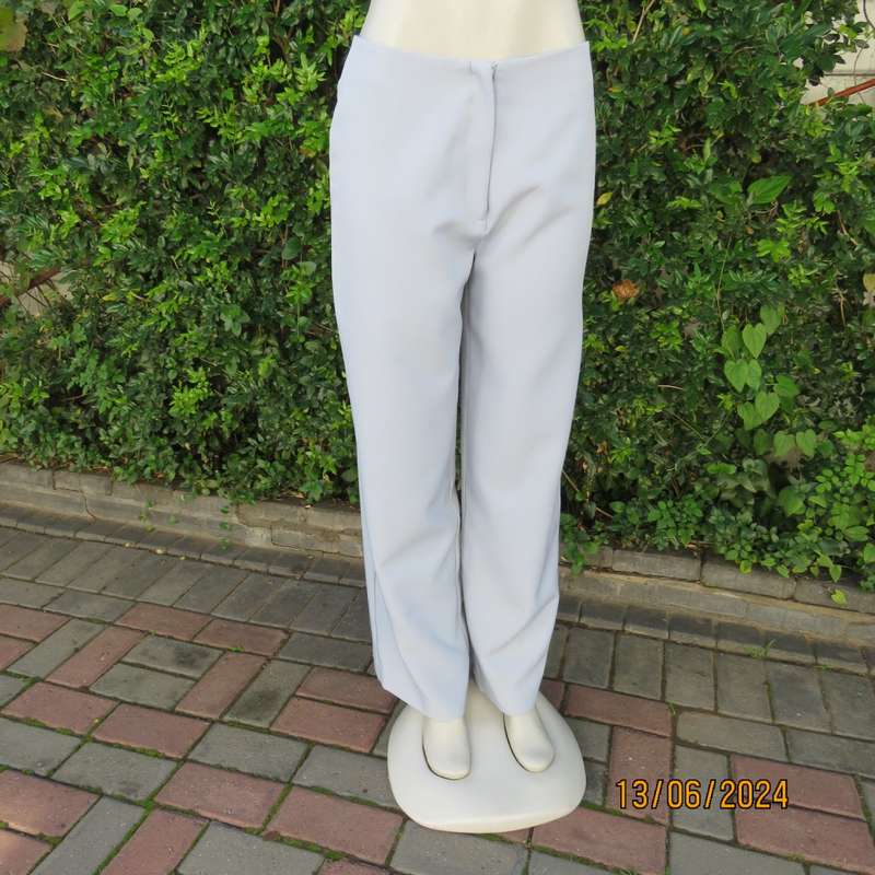 Bandless carolina blue straight legged dress pants in 100% polyester. Size 36 by SMILEY. As new